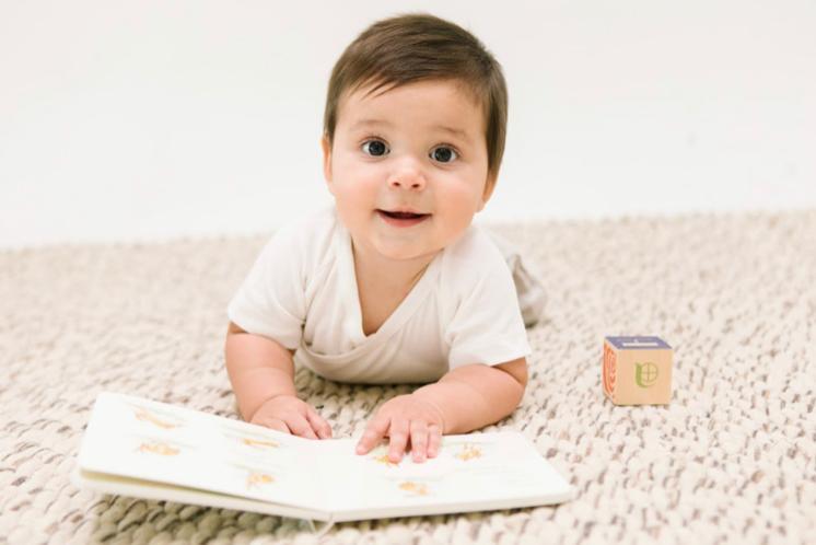 8, 9, 10 month old playing on the floor with a book and a block, 8-10 month sleep regression