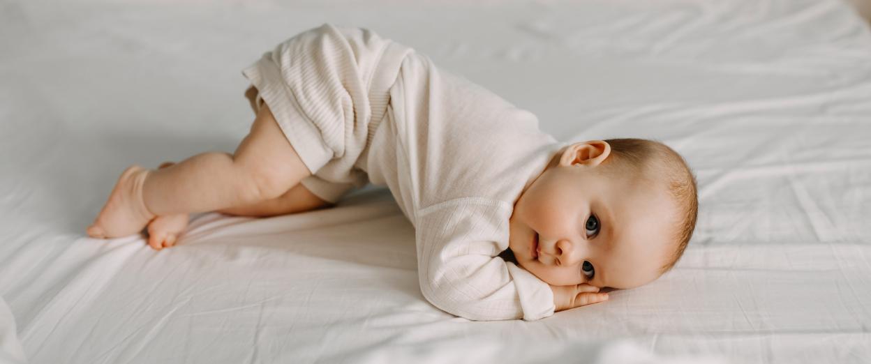 baby practicing rolling over