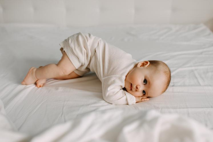 baby practicing rolling over