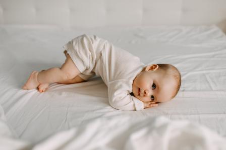 baby practicing rolling over