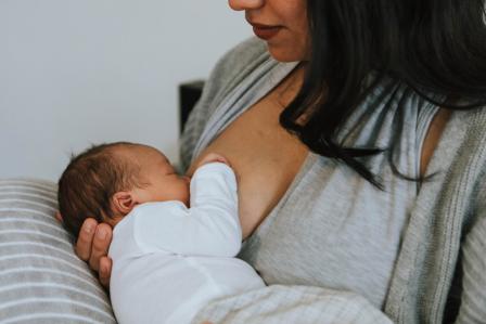 new mom breastfeeding newborn baby