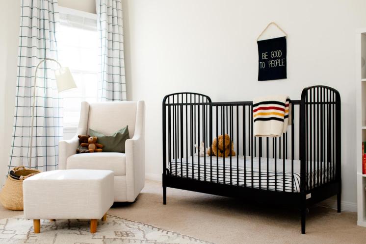 modern gender neutral nursery with black crib