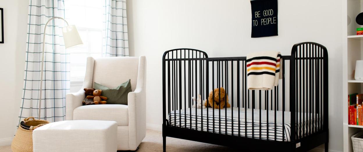 modern gender neutral nursery with black crib