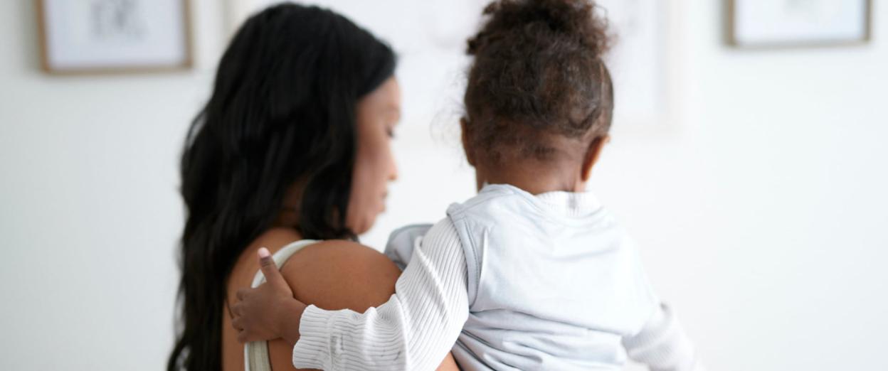 Mom dressing baby for sleep