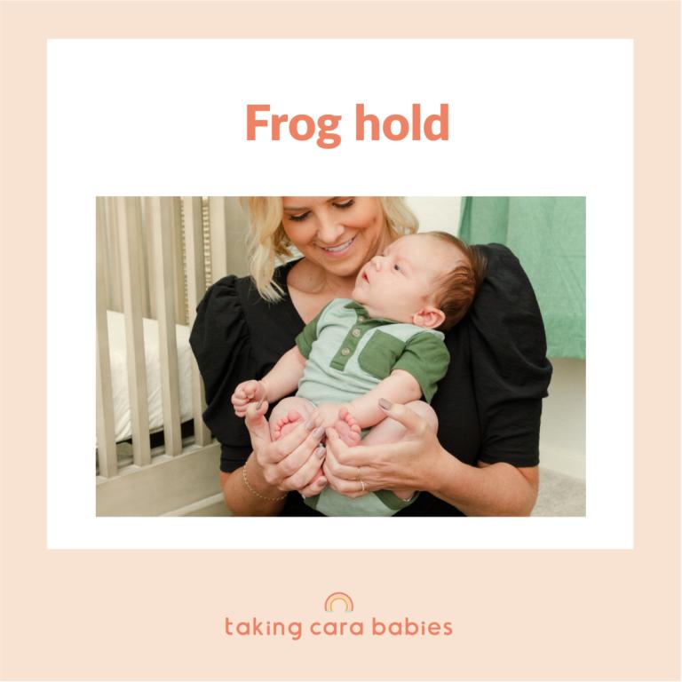 newborn being held by woman smiling at baby