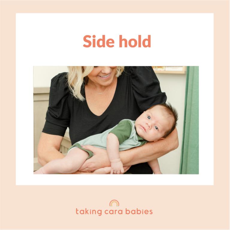 newborn being held on arm of adult woman with newborn's back to woman's chest and stomach along arm of adult