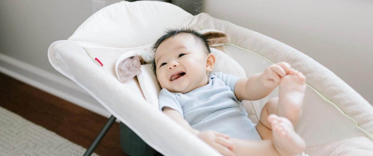 Baby awake in rock n play being supervised, weaning out of unsafe sleep products