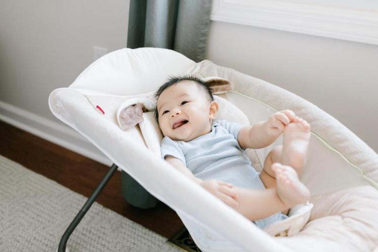 Baby awake in rock n play being supervised, weaning out of unsafe sleep products