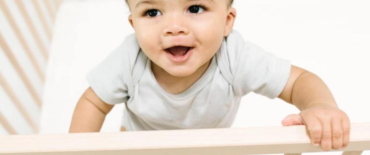 baby standing in crib for safe sleep