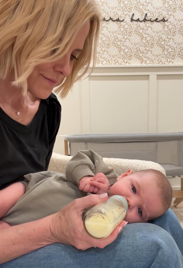 baby laying on side on lap for bottle feeding