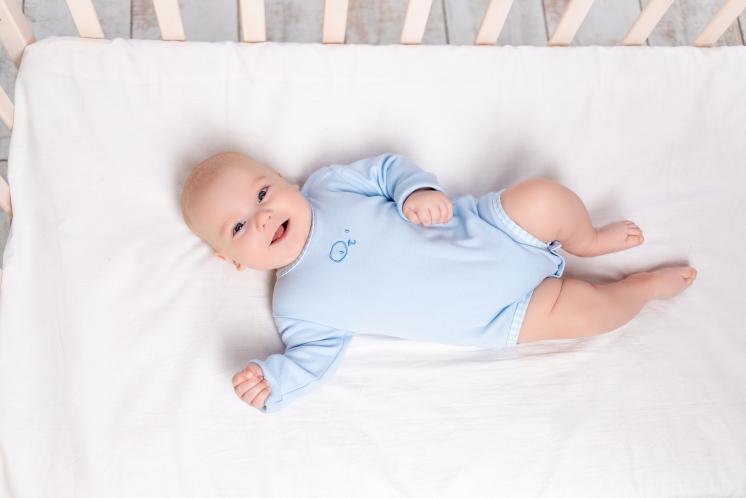 baby laying happily in crib since he is ready to drop a nap