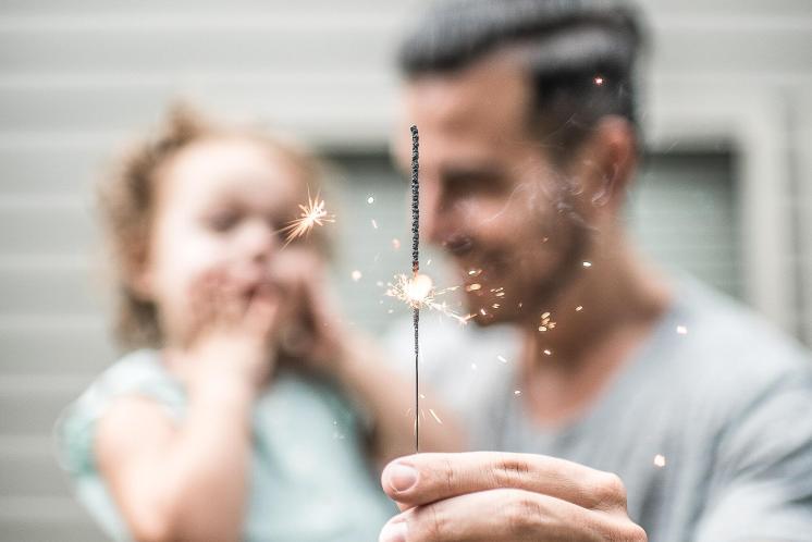 Daddy and baby looking at sparkler