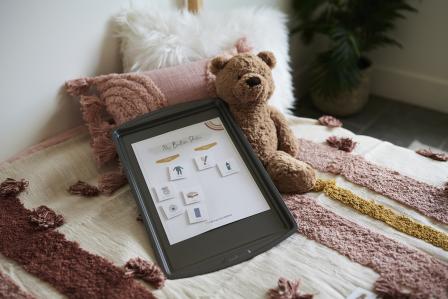 magnetic bedtime routine chart on bed with teddy bear
